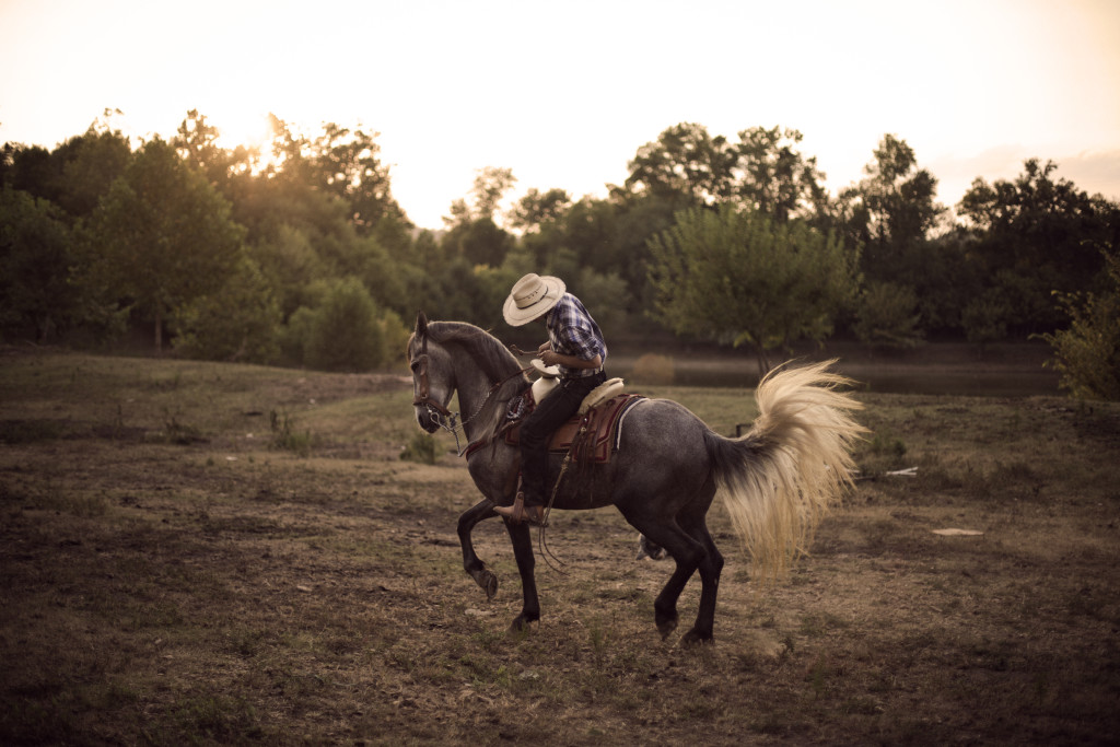 Marcos Espinosa, 17, from Mexico and Guatamala is takes his horse, Maximilliano, for a ride on his uncles ranch in Bowling Green Kentucky. Espinosa represents a group of young hispanics who are split between the American and Hispanic culture.