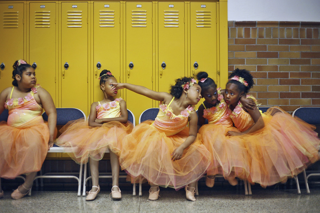 A group of La'Nita School of Dance members wait impatiently in the hallway of Shawnee High School before performing a routine during the annual Father's Day dance recital.