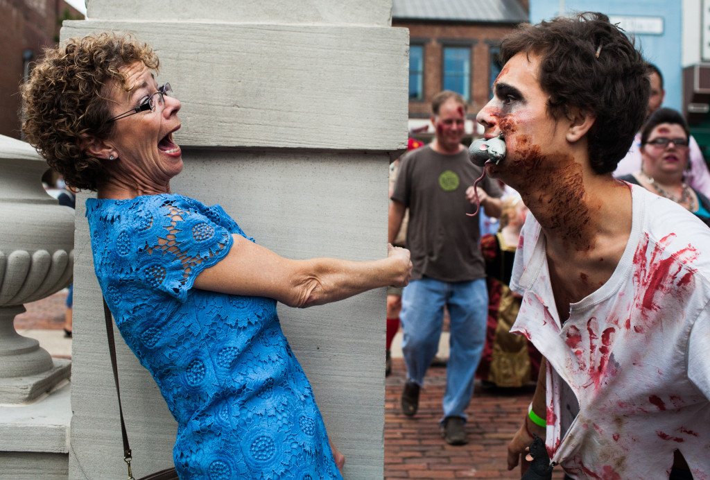 Marlene "Mo" Beach, left, was headed to a wedding when she was bombarded by a swarm of zombies in downtown Bowling Green, Saturday. Jacob Glass, right, participated in the Zombie Walk that was held to raise awareness and funds for the third-world tetanus crisis. WESTON KENNEY