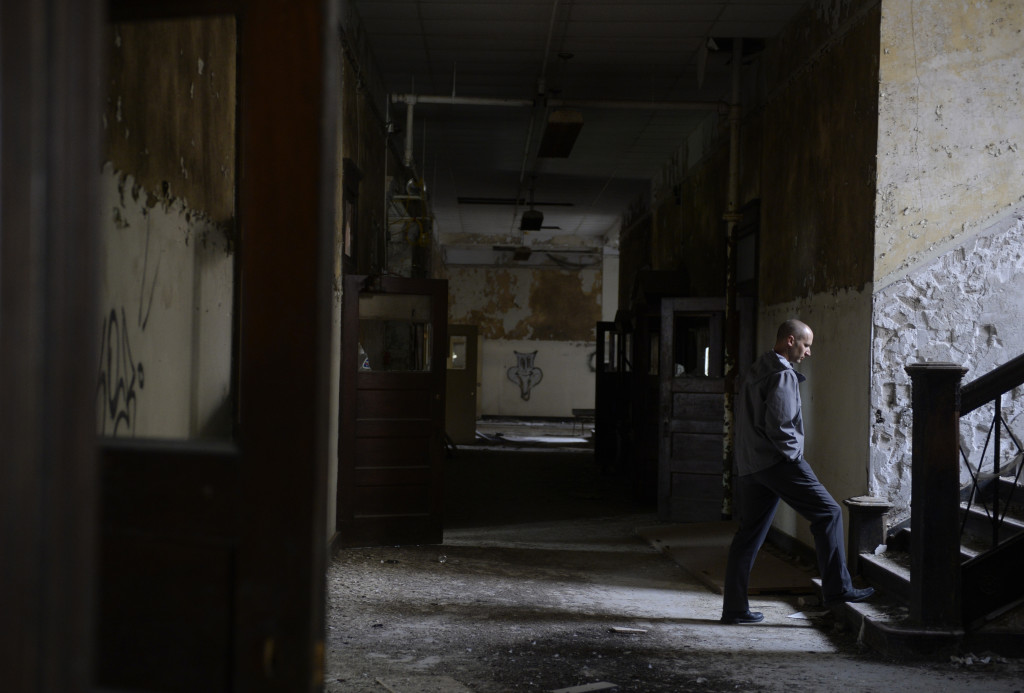 Burlington's Community Development & Parks Director Eric Tysland walks up a staircase Monday, Oct. 19, 2015, during a tour of the Apollo School building in Burlington, Iowa. The former school was constructed in 1908. The city of Burlington is seeking a developer for the dilapidated facility. JEFF BROWN