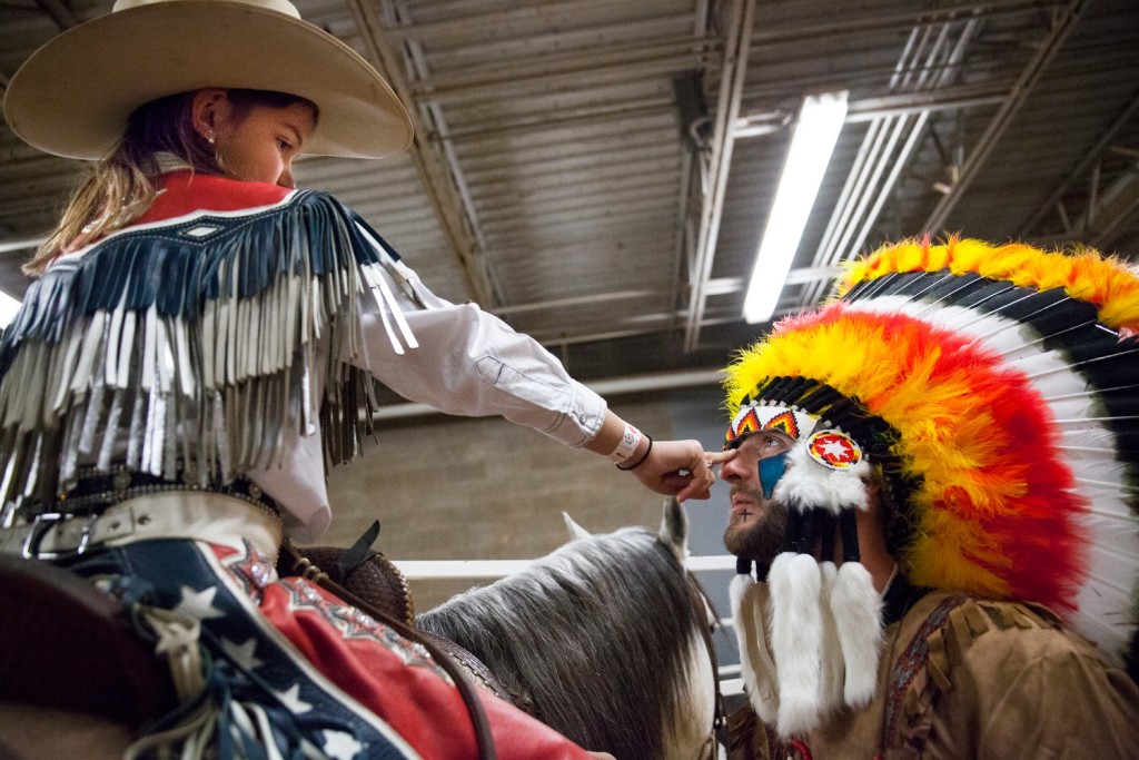 Oralee Madison, 8, checks bull fighter Chris Russell's face paint before the start of the Lone Star Championship Rodeo at the L.D Brown Agricultural Exposition Center in Bowling Green, Kentucky on Sunday, February 14th, 2016.|Skyler Ballard