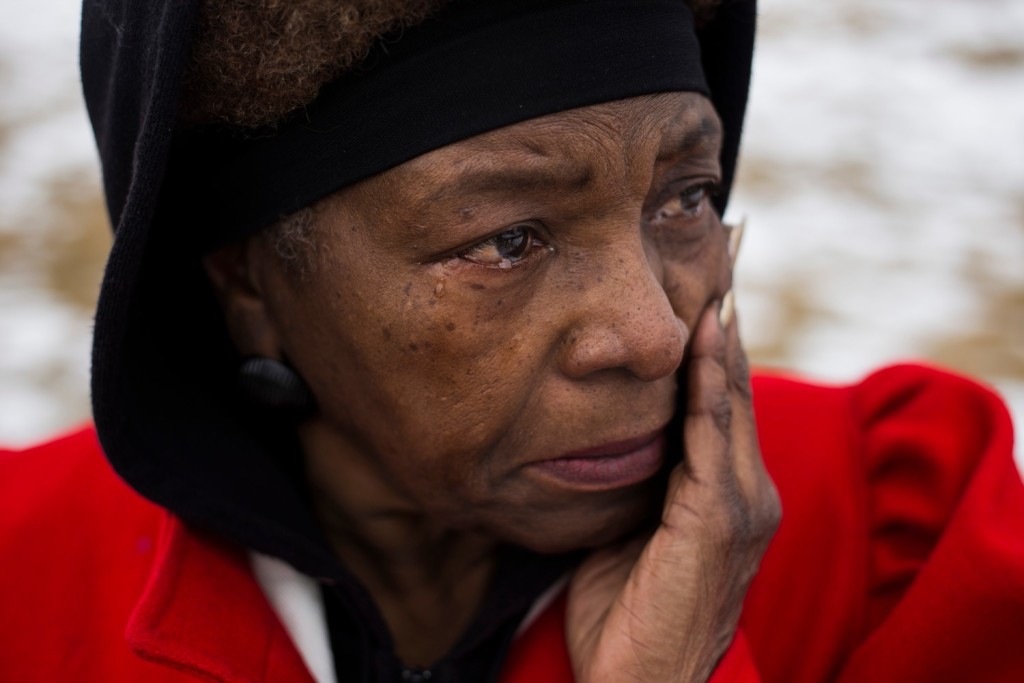 Gail Morton, 64, of Flint, Mich., sobs as she watches protestors gather following a scheduled march with the Rev. Jesse Jackson that made it's way from the Metropolitan Baptist Tabernacle Church over a mile to the front of the the City of Flint Water Plant, on Friday, February 19, 2016. "As a small child growing up you could almost see what our parents went through. We didn't have the rights. We didn't even have the rights to live in certain neighborhoods," Morton said. "I am so proud today, I mean, I am really proud." |Brittany Greeson
