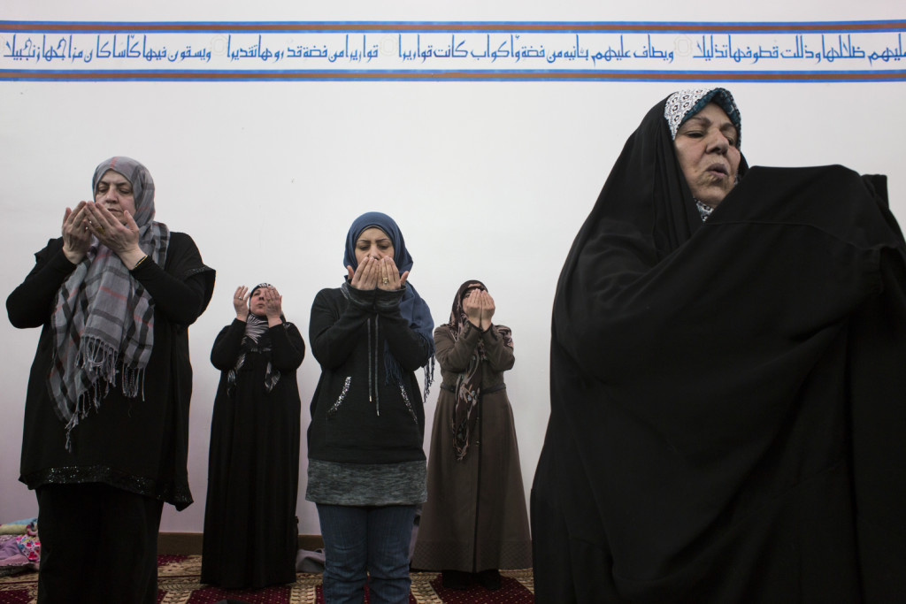 Detroit, Michigan - March 4, 2016: Members of the congregation lift their hands in prayer during a noon service at the Az-Zahra Islamic Center in Detroit, Mich., on Friday, March 4, 2016. Az-Zahra's imam, a prayer leader, Hassan Qazwini, used the service as an opportunity to discuss voting and his view of Republican Presidential Candidate Donald Trump, who he said he believes is unfit to be president.
