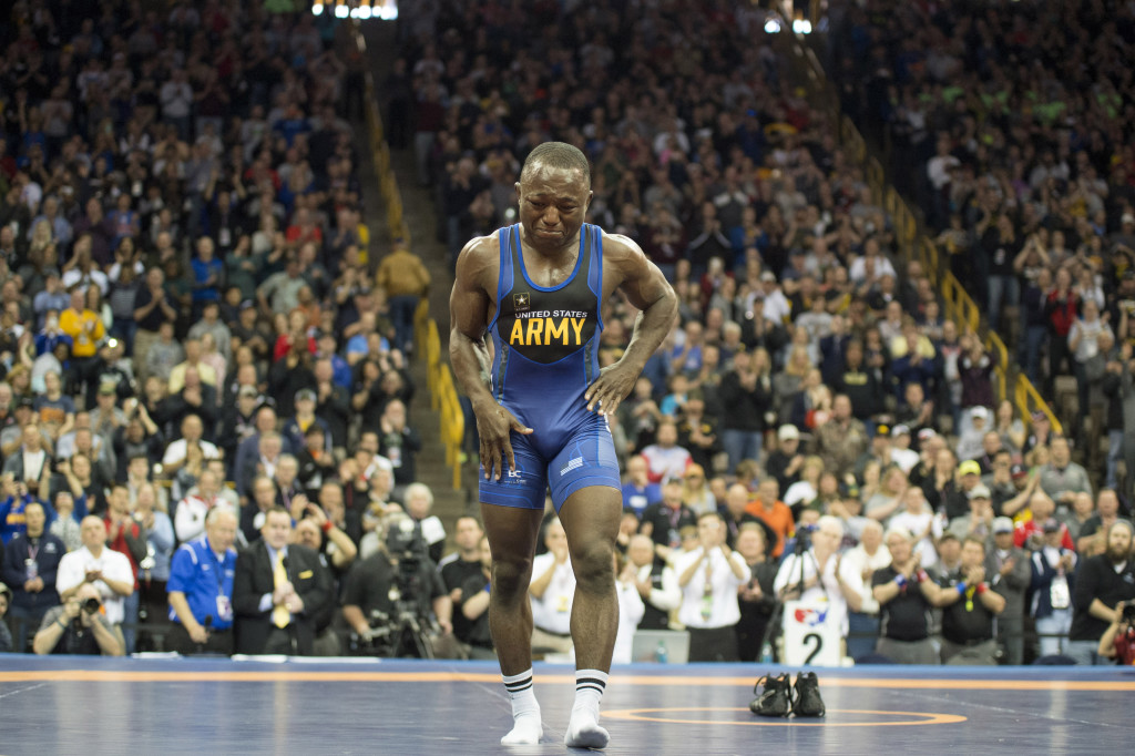 Former two-time Olympian and Army wrestler Spenser Mango, of St. Louis, walks off the mat retiring from wrestling after losing to Jesse Thielke, of Germantown, Wisconsin, in the Semi Finals match of 59 KG in greco roman during the US Wrestling Olympic Team Trails Saturday, April 9, 2016, at Carver Hawkeye Arena in Iowa City, Iowa. "When I first started trying to take my shoes off I thought I was just going to take them off real quick and get out of there because I knew I wasnÕt going to be able to hold my emotions back. I heard everybody cheering for me. You know, you go through your whole career I guess hoping that when youÕre done you feel like youÕre appreciated and the crowd was great," said Mango after his match. Mango competed on the US Olympic team in 2008 and 2012. Jeff Brown/The Hawk Eye