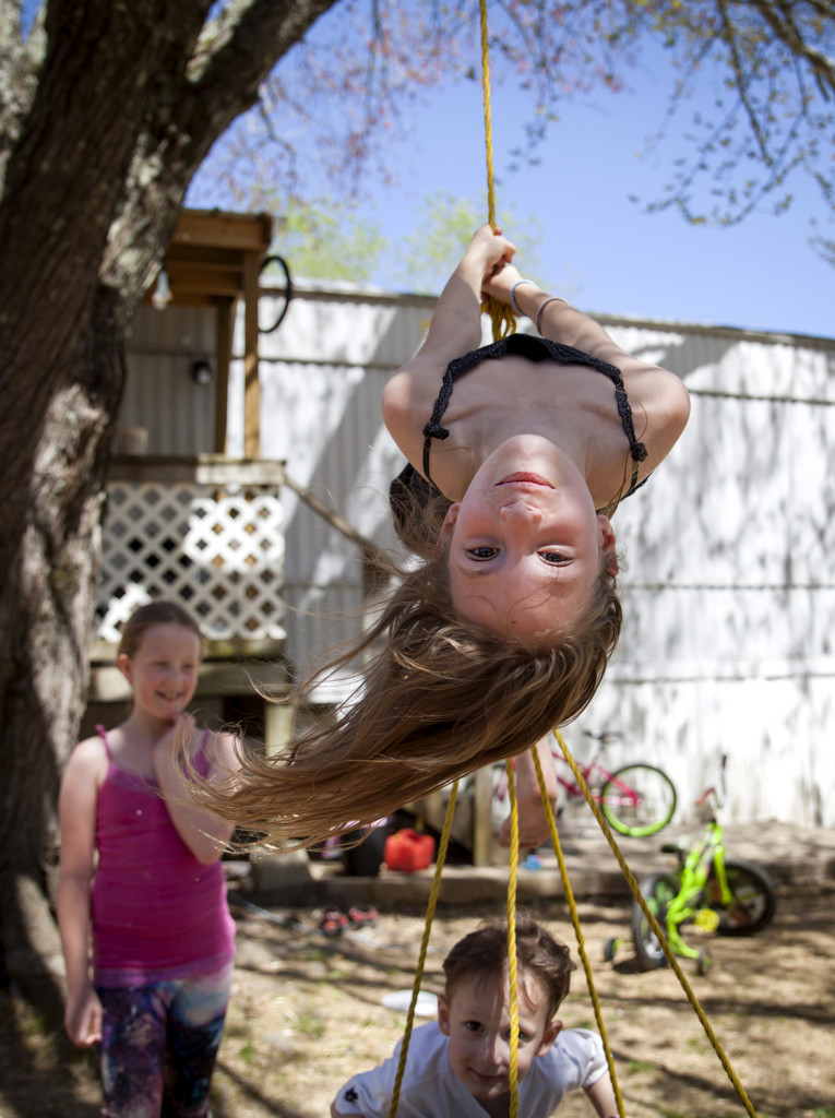 SUNDAY, APRIL 17 2016--BROWNSVILLE, KY-- Abby McPeak, 7, and her siblings Jazmine, 9, and Dathan, 3, play in the front yard of their trailer home outside of downtown Brownsville, Ky. "I like this place because we have a trampoline and friends that play with us," said Abby. (Photo by Skyler Ballard)