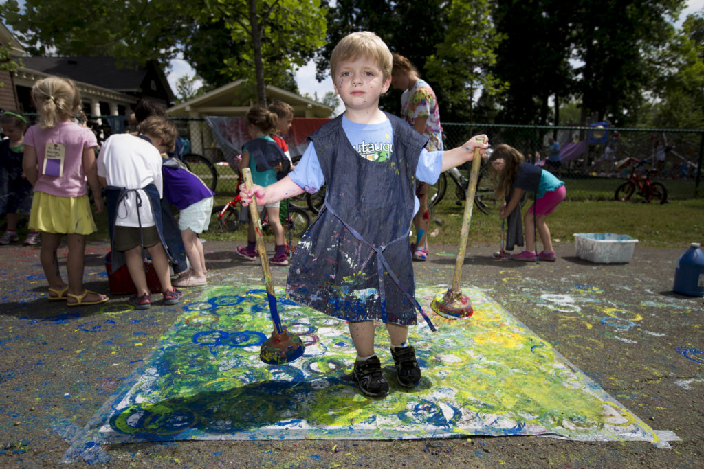 Russell Gardner, 5, holds plungers he used as paintbrushes during the Big Art Everywhere activities Wednesday, July 6, 2016, at the Children's School.