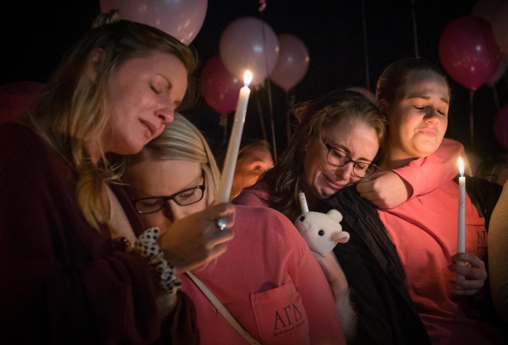 From left to right, Hayley Hoback, Izzy Rager, Morgan Goetz and Rachel Shipp lean on one another at a vigil to memorialize their Alpha Gamma Delta sister, Stephanie Campbell, on Wednesday, Sept. 28 at the AGD sorority house. Campbell passed away Sunday, Sept. 25 as a result of a single-car accident on the Western Kentucky Parkway. "She has tattooed on her foot 'You can breathe,'" remembered Hayley Hoback at the vigil. "And that's what I can say to her. 'You can breathe now.' She's in a better place now.Ó | Photo by Gabriel Scarlett