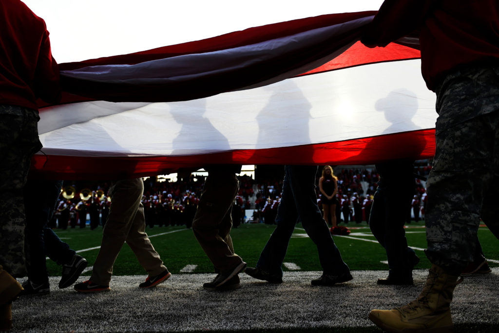 Boys scouts and members of the military bring out a flag before the national anthem in an NCAA college football game, Saturday, Nov. 5, 2016, in Bowling Green, Ky.